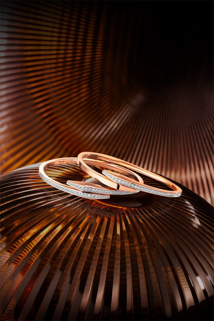 Rose gold diamond bangle and ring on a bronze fluted set