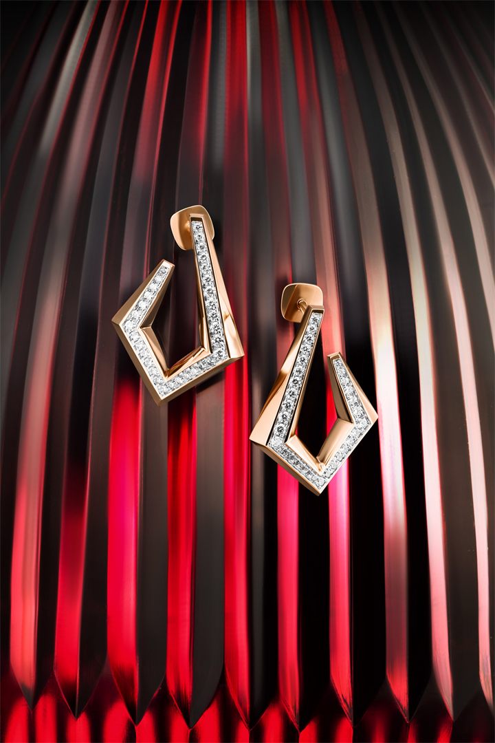 Rose gold geometric diamond jewellery on red fluted glass