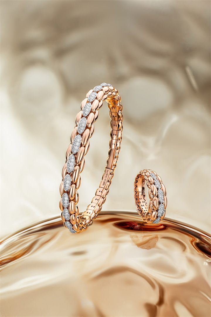 Rose gold and diamond bracelets and pendants on textured amber glass