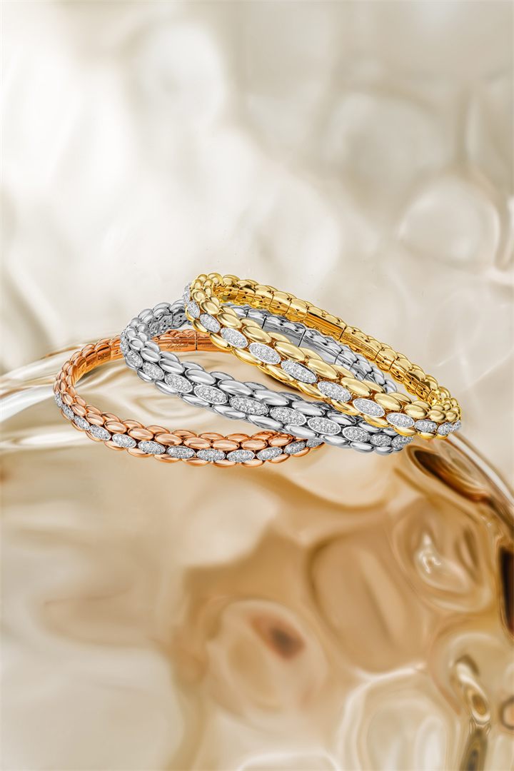 Rose gold and diamond bracelets and pendants on textured amber glass