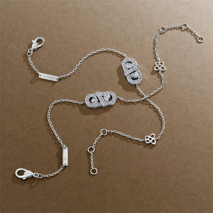 Silver charm bracelets flat lay on taupe