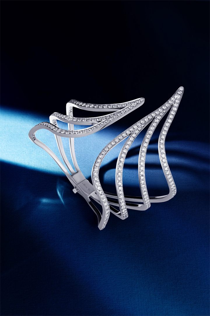 White gold diamond wing cuff on navy with directional light