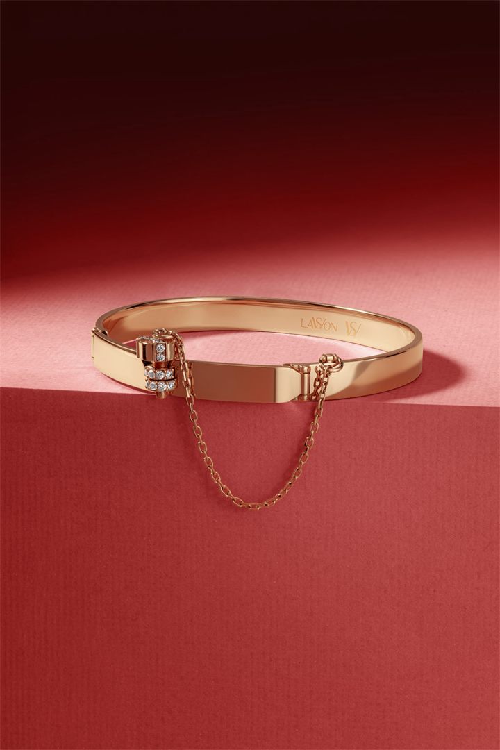 Gold bangle and ring on a red set
