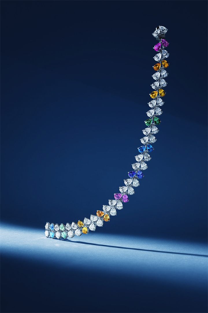Diamond and coloured gemstone high jewellery on a navy sculpted set