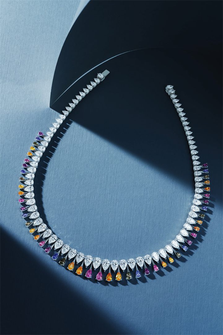 Diamond and coloured gemstone high jewellery on a navy sculpted set
