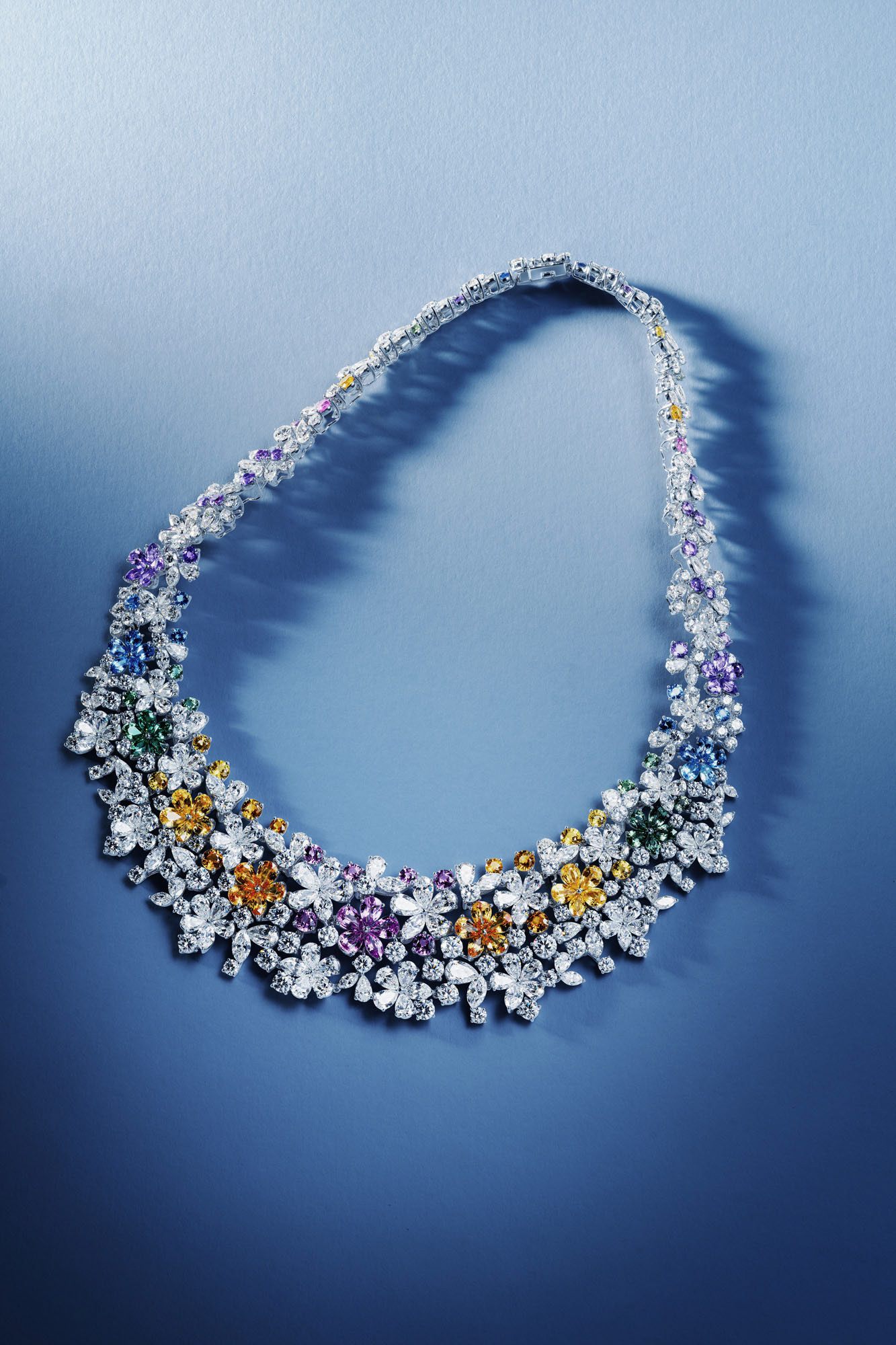 Gemstone and diamond necklace on a blue set, photographed by Moataz Hachem
