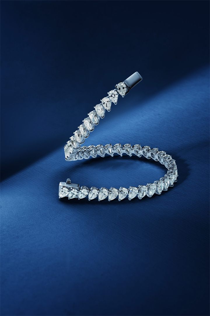 Diamond and coloured gemstone high jewellery on a navy sculpted set