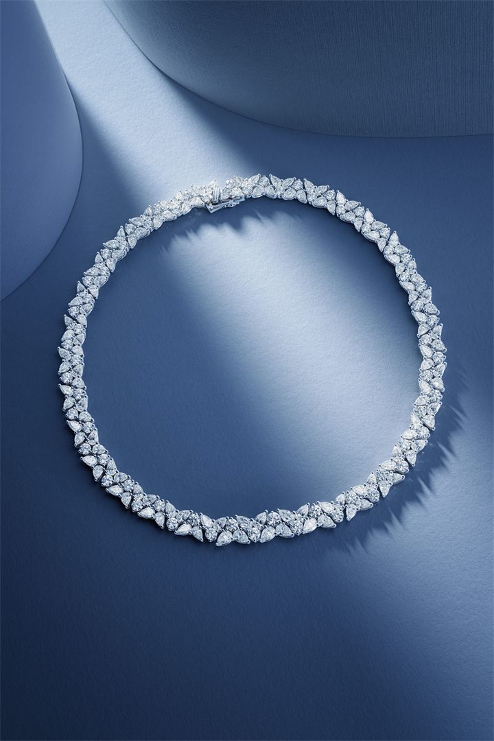 Diamond and coloured gemstone high jewellery on a navy sculpted set