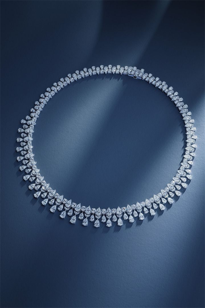 Diamond and coloured gemstone high jewellery on a navy sculpted set