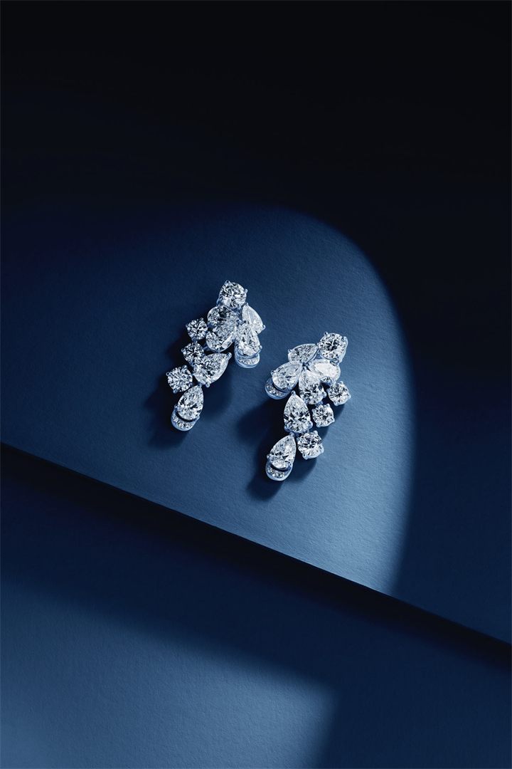 Diamond and coloured gemstone high jewellery on a navy sculpted set