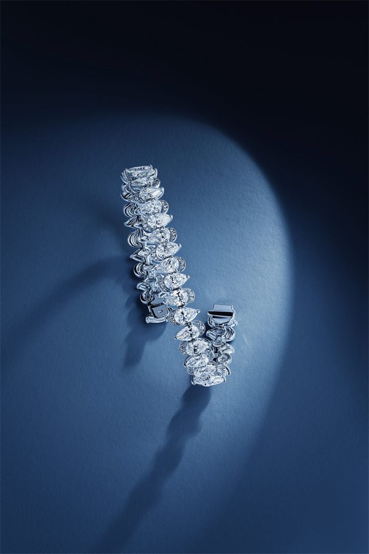 Diamond and coloured gemstone high jewellery on a navy sculpted set