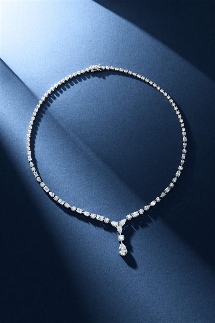 Diamond and coloured gemstone high jewellery on a navy sculpted set