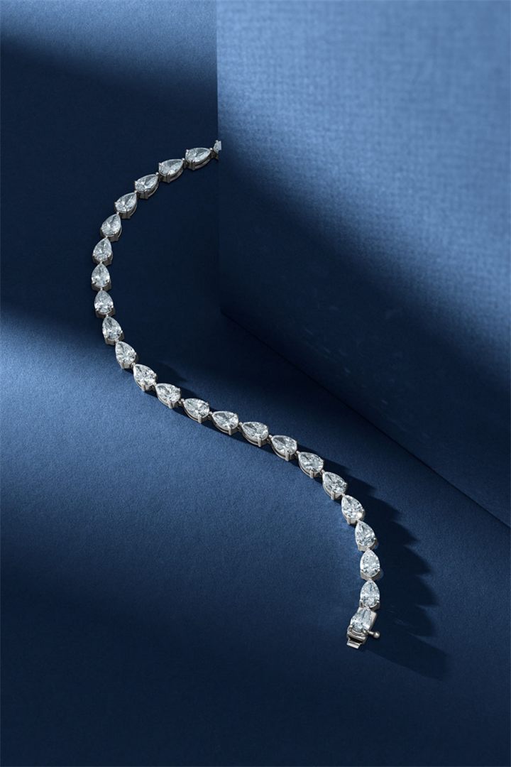 Diamond and coloured gemstone high jewellery on a navy sculpted set