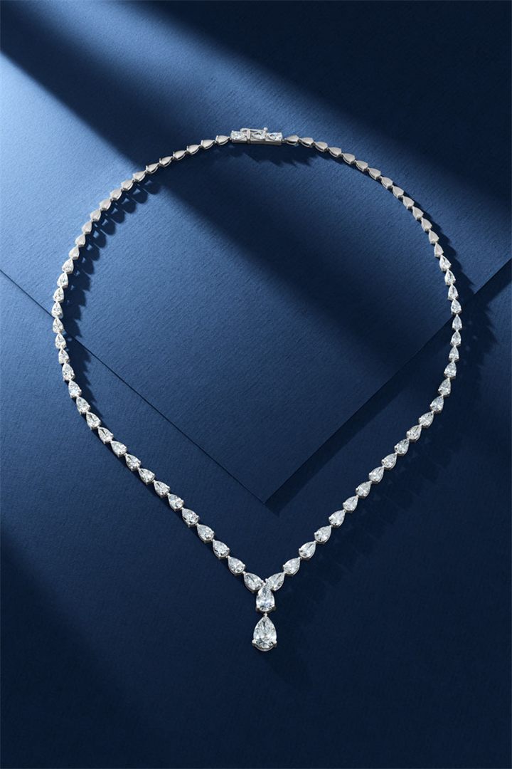 Diamond and coloured gemstone high jewellery on a navy sculpted set