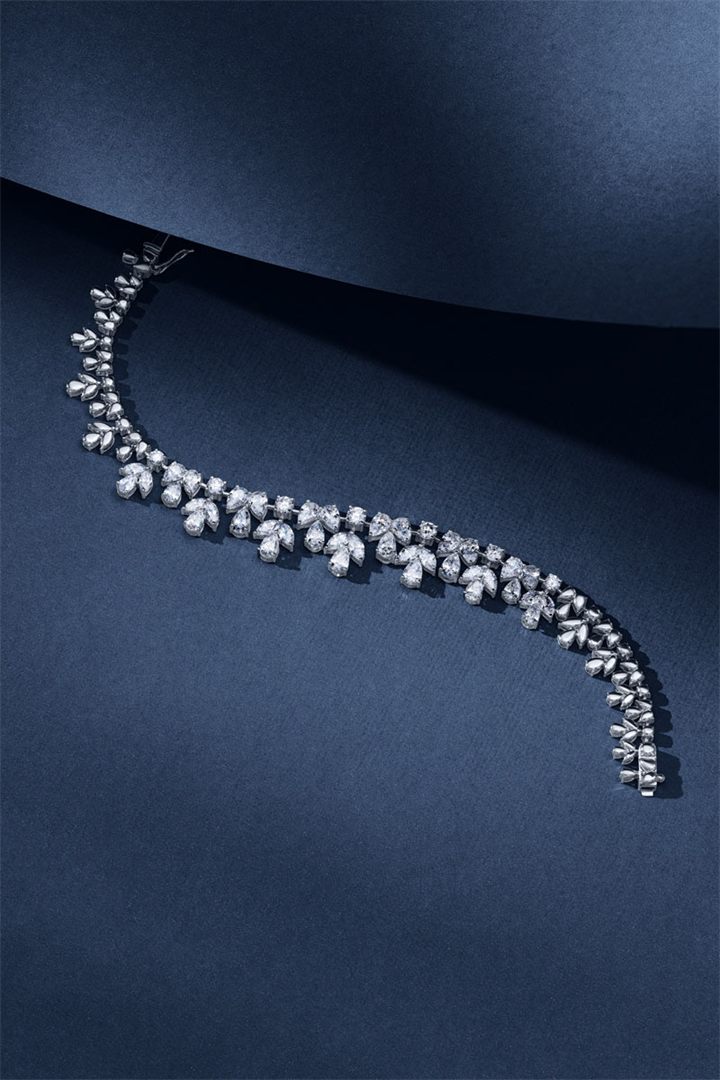 Diamond and coloured gemstone high jewellery on a navy sculpted set