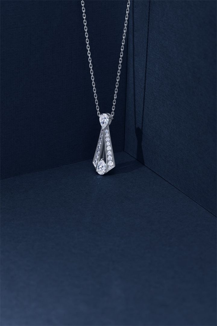 Diamond and coloured gemstone high jewellery on a navy sculpted set