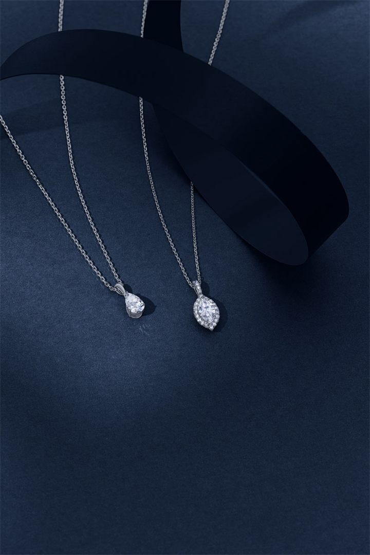 Diamond and coloured gemstone high jewellery on a navy sculpted set