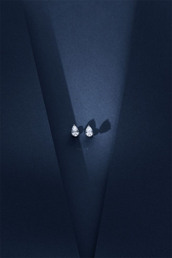 Diamond and coloured gemstone high jewellery on a navy sculpted set