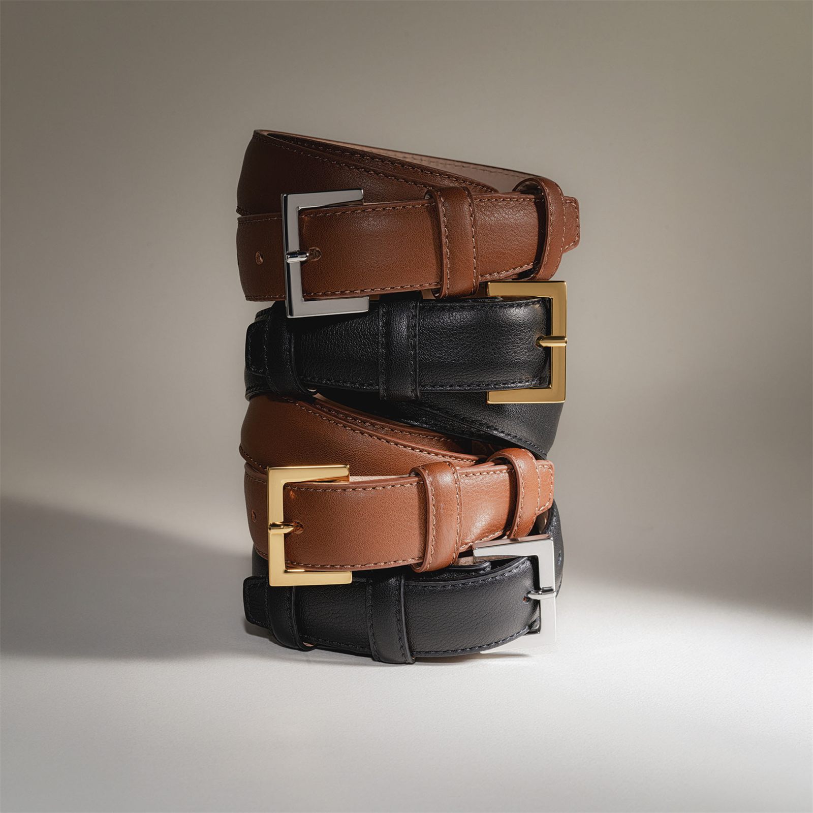 Stacked leather belts, product photography in Dubai